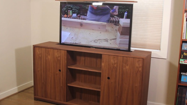 A custom TV cabinet with the TV opened at the top.