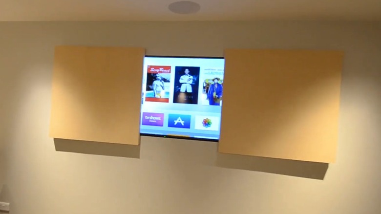 A set of doors opening to reveal a TV.