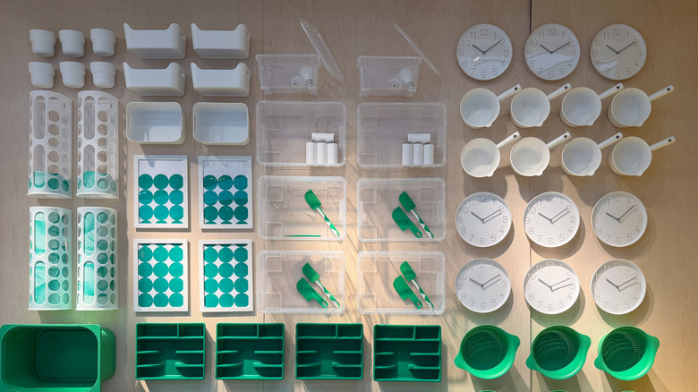 Green and white Ikea household items on display in an Ikea showroom