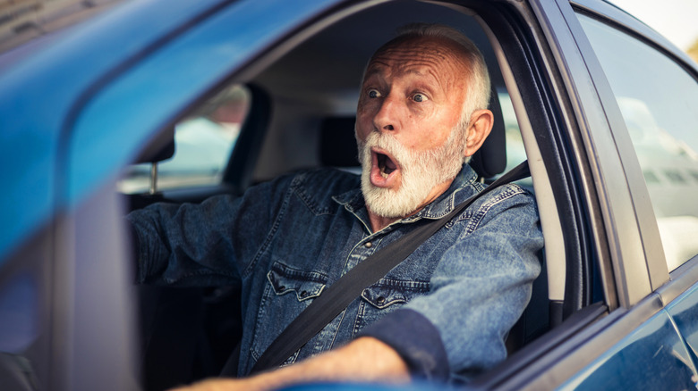 man in car with shocked expression