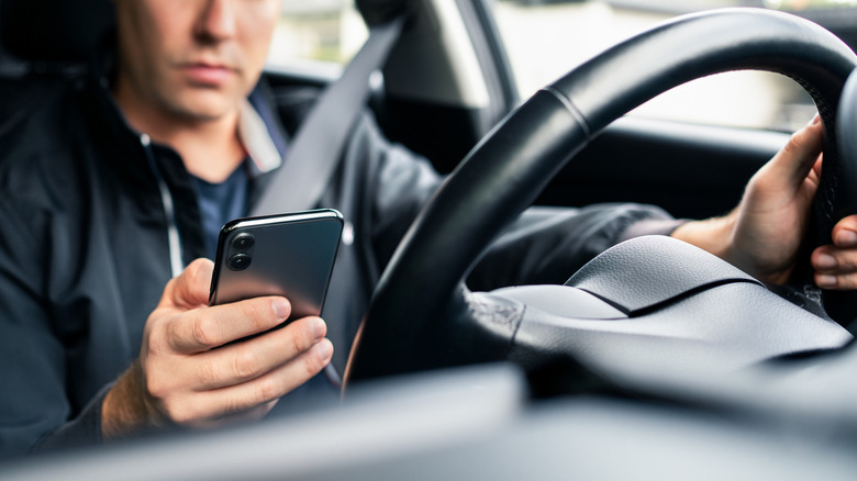 driver looking at his phone