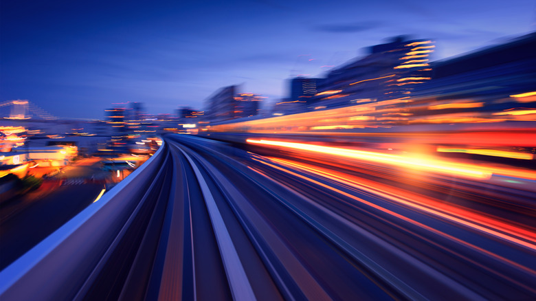 long exposure image of road with travel lights speeding by