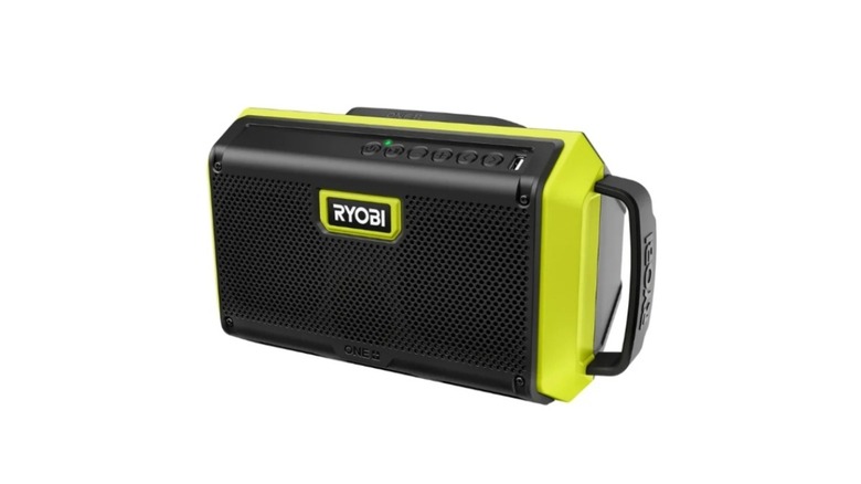Green and black Ryobi brand speaker with handle on white background