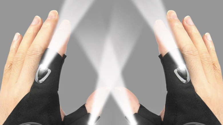 Hands wearing the Moipejo LED flashlight gloves with lights on