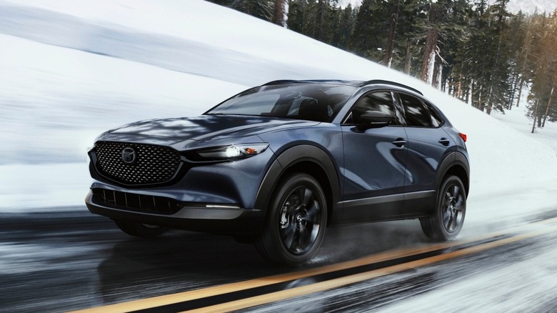 Mazda CX-30 driving down a road in winter
