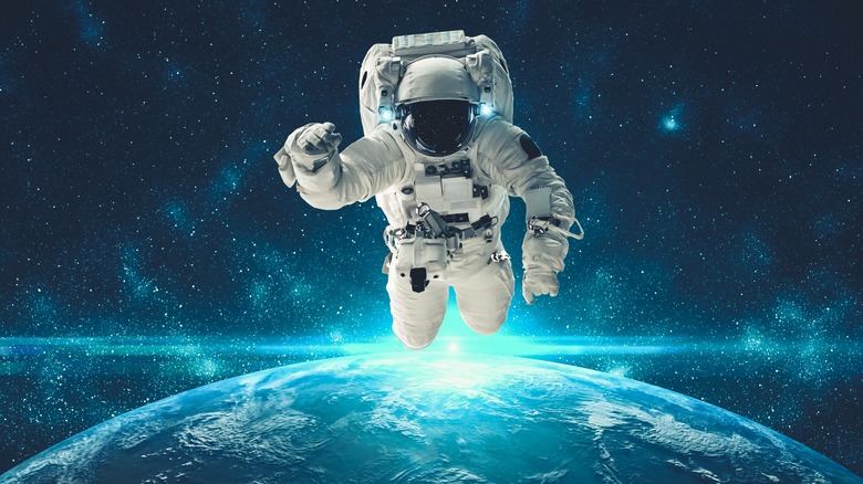 astronaut floating above Earth