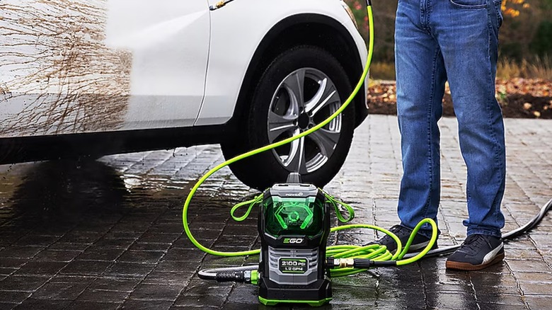 spraying a car with Ego pressure washer
