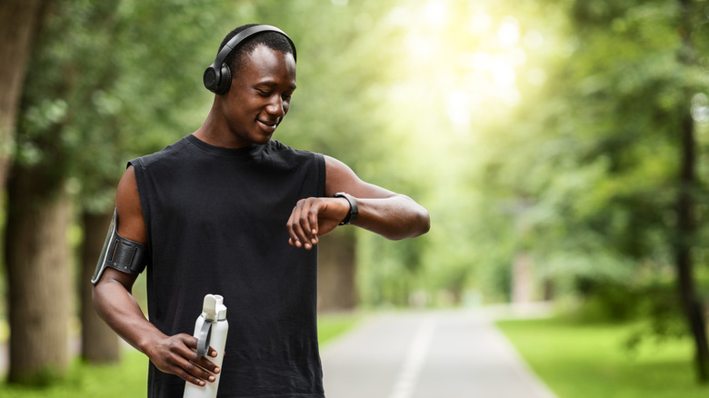 man looking at smartwatch