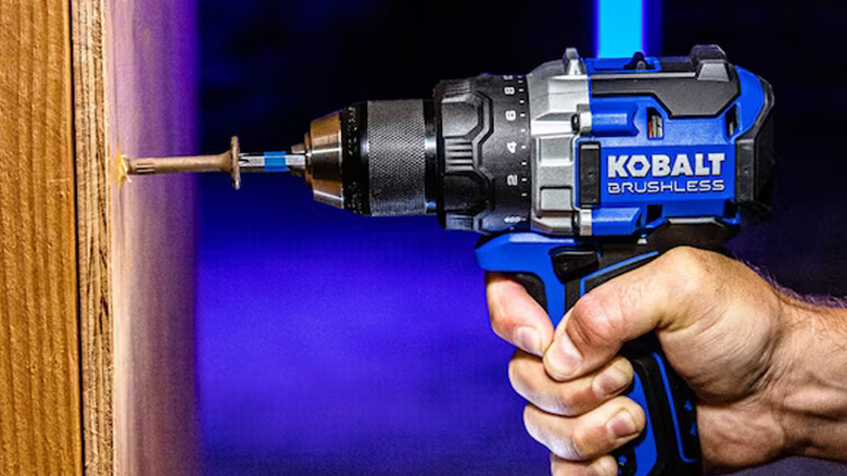 person using kobalt drill