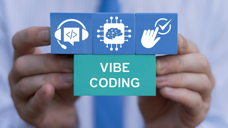 Hands holding a sign that says Vibe Coding