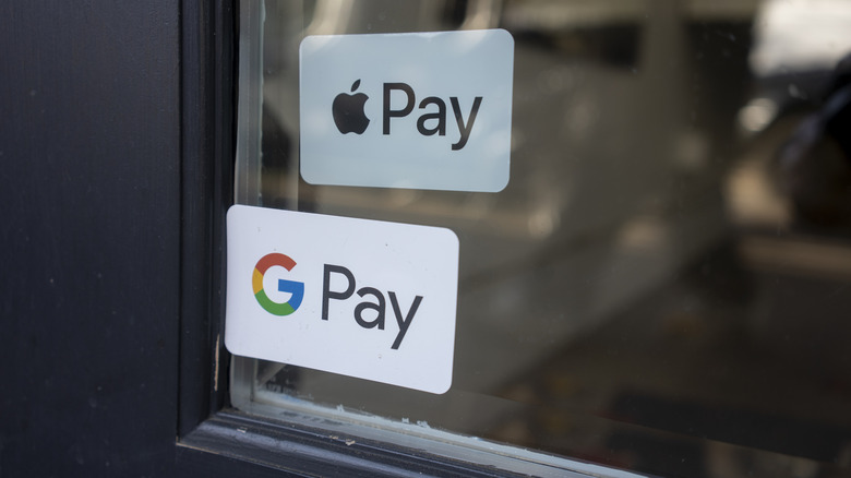 Google Pay and Apple Pay stickers on a retail store window