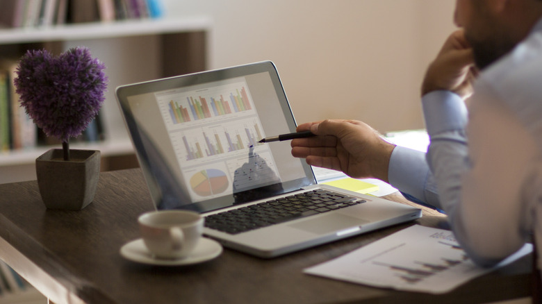 Person touching the screen of a laptop