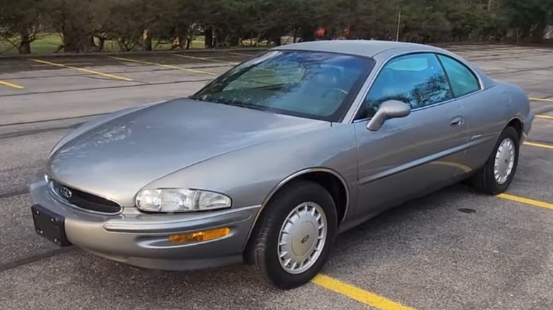 Silver Buick Riviera in an empty parking lot