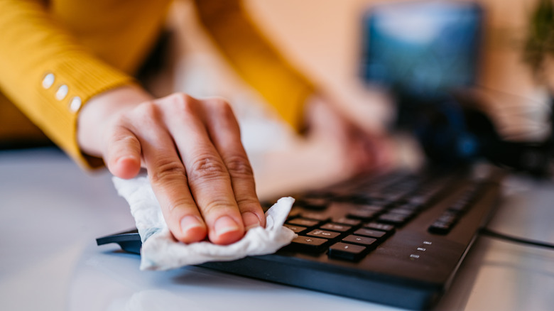 cleaning keyboard with a tissue paper