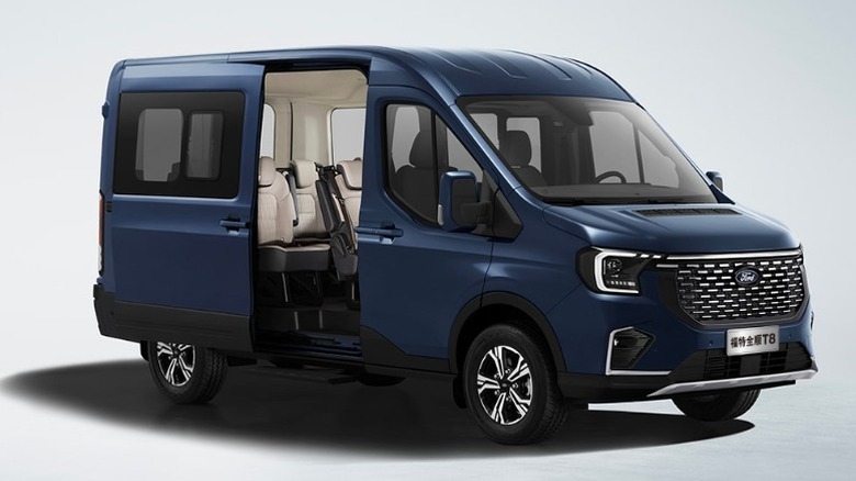 A blue Ford Transit T8 with a side door open in front of a gray background