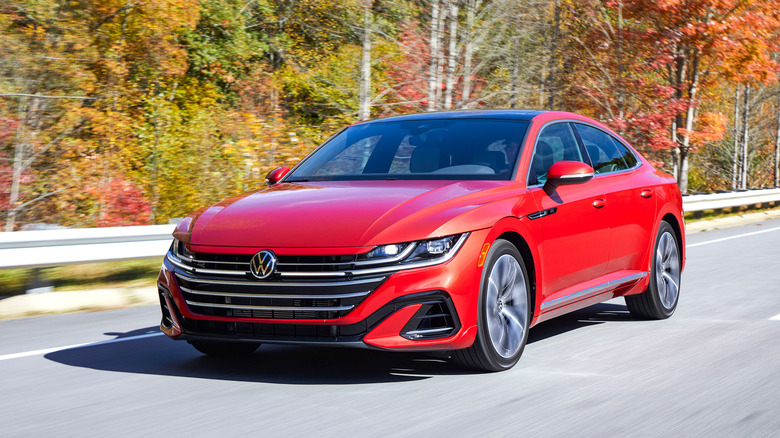 A frontal 3/4 shot of a red 2023 Volkswagen Arteon driving