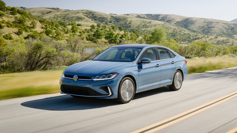 A frontal 3/4 of a light blue 2026 Volkswagen Jetta driving