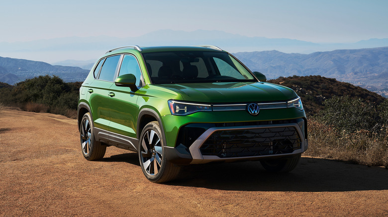A frontal 3/4 of a green 2026 Volkswagen Taos