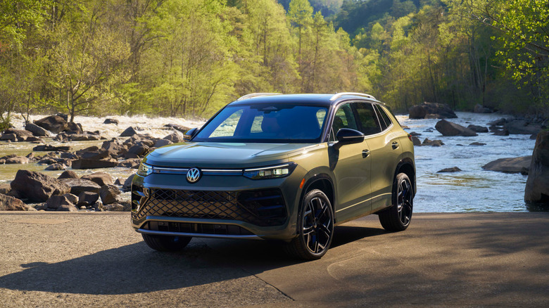 A frontal 3/4 shot of a green 2026 Volkswagen Tiguan