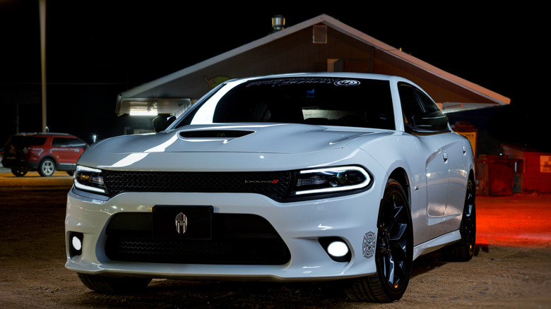 white 2018 Dodge Charger in front of a building.