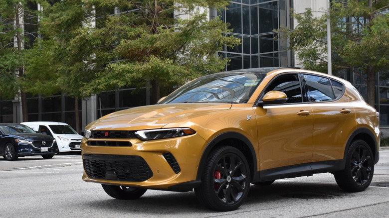 gold Dodge Hornet in city parking lot