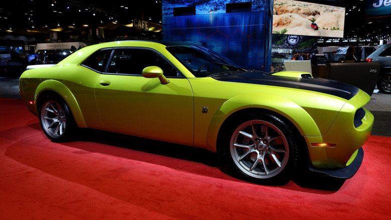 A lime green 2020 Dodge Challenger on display at an auto show.