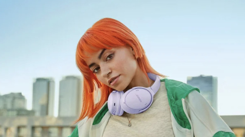 woman wearing purple bose headphones