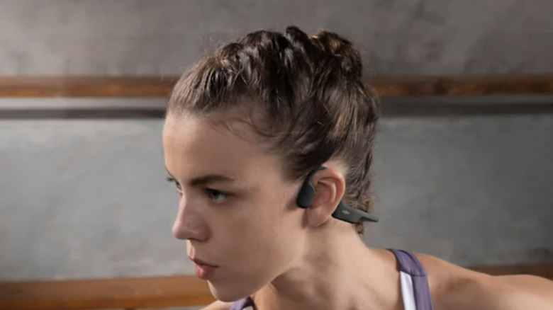woman wearing Shokz earphones