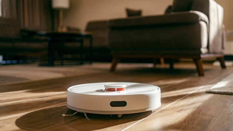 A robot vacuum cleaner on a hardwood floor