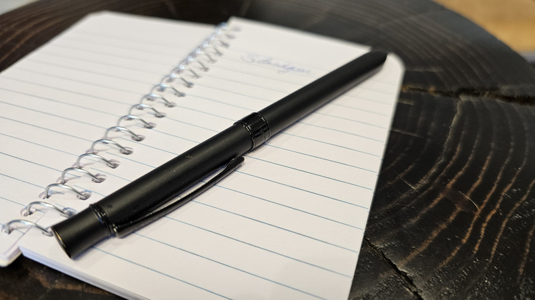 Pen and notebook on table