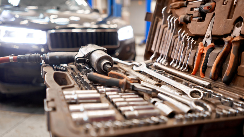 Dirty set of tools strewn about in a toolbox