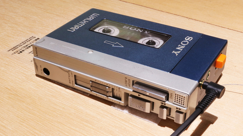 1980 aluminum-case Sony Walkman with tape and headphone inserted