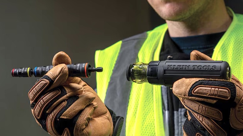 Person holding two ends of Klein Tools impact flip socket