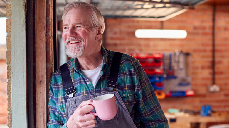 Man smiling inside of his home garage