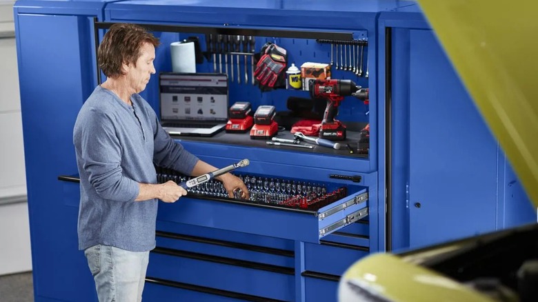 Person grabbing a socket from a blue U.S. General 56 x 22-inch Roll Cab (Series 3)