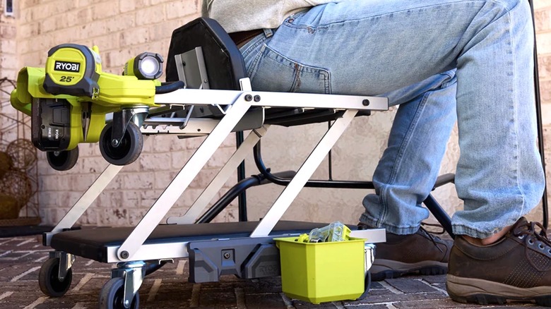 Person sitting on Ryobi creeper seat