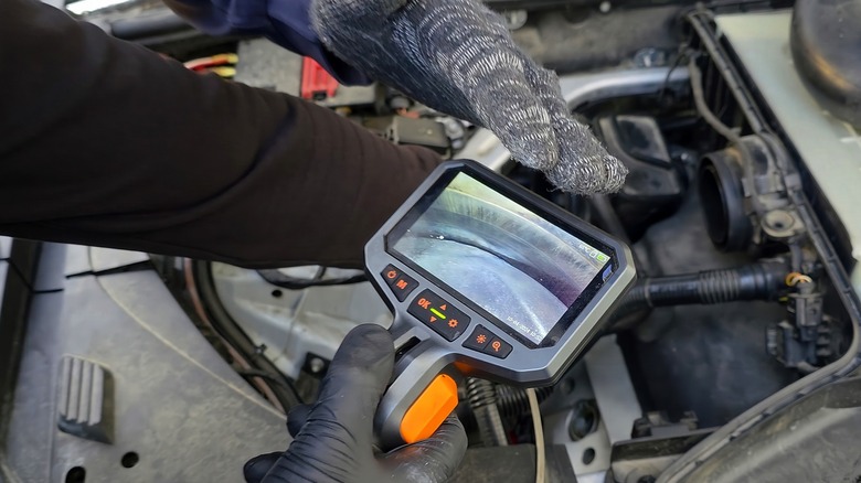 Using a borescope to inspect car