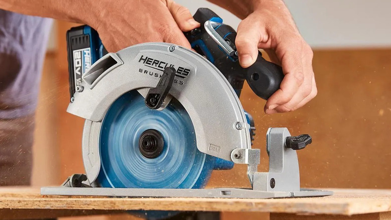 Man cutting board with Hercules 7-1/4 Inch circular saw