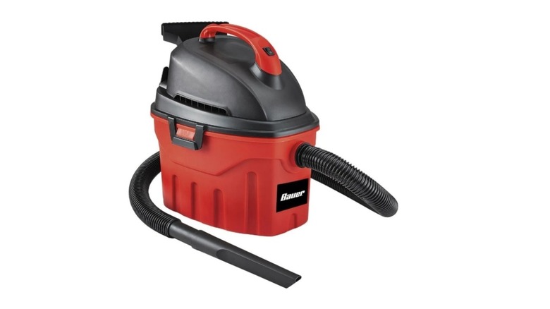 Black and red shop vac with hose with Bauer branding