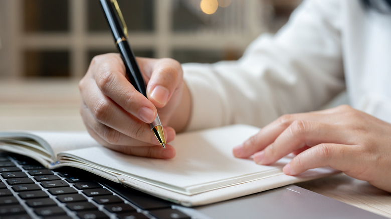 Using a pen and paper to write a list