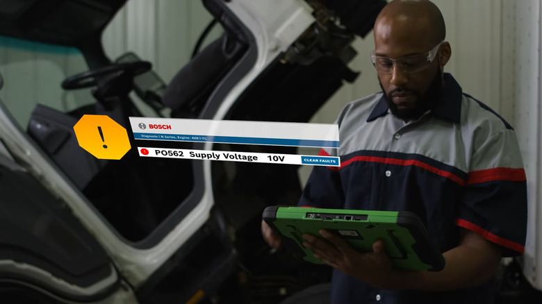 Bosch mechanic working on heavy duty truck using the ESI Tablet