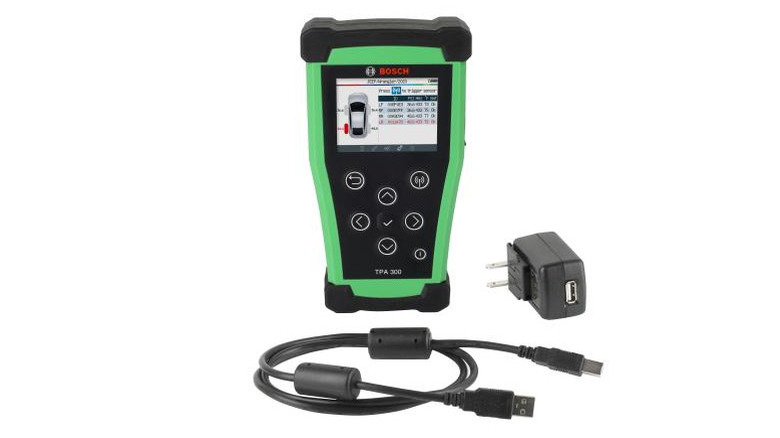 The Bosch TPA 300 with charger and cable on a white background