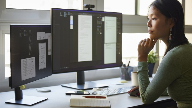 person using two external monitors