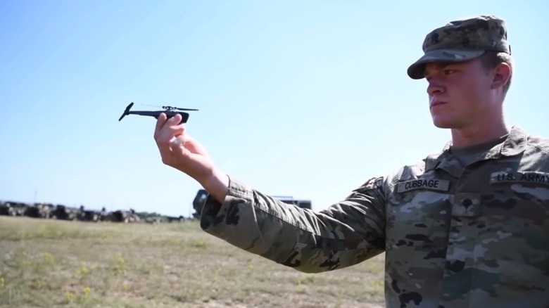 US army personnel holding a pocket drone