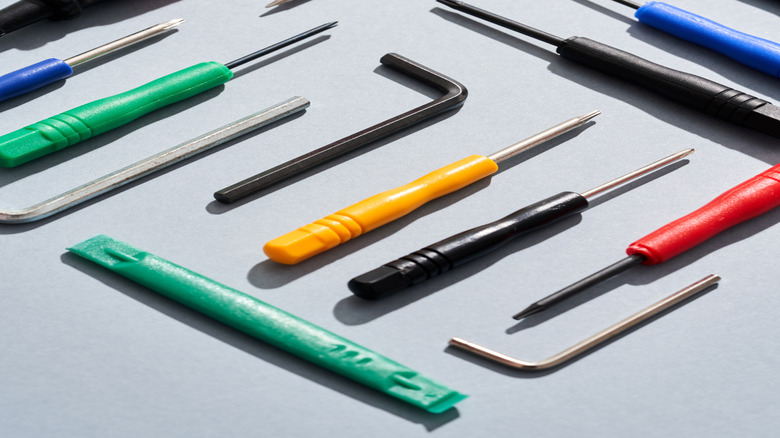overhead view of hand tools on gray background