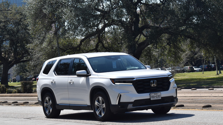 A Honda Pilot driving on a sunny day.