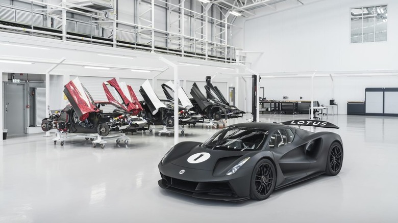 Lotus Evija in assembly hall with several chassis under construction in the background