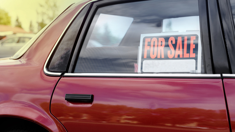Car with for sale sign in window