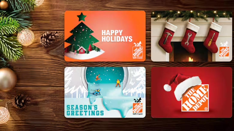 Four Home Depot gift cards next to Christmas decorations