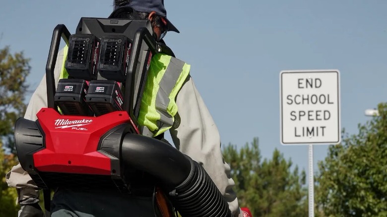 Person using Milwaukee M18 Fuel Dual Battery Backpack Blower